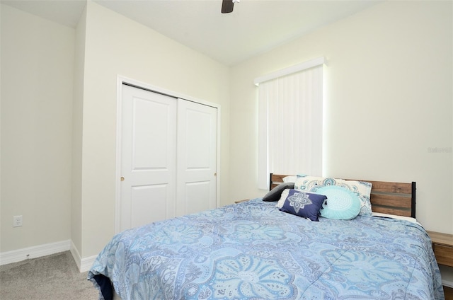 carpeted bedroom featuring ceiling fan and a closet