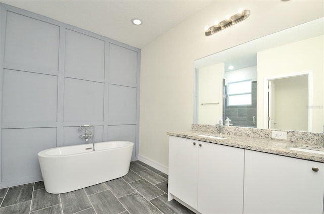 bathroom with vanity and a bathing tub