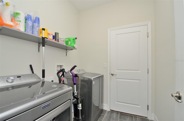 laundry room with separate washer and dryer and dark hardwood / wood-style flooring