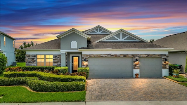 view of front facade featuring cooling unit and a garage