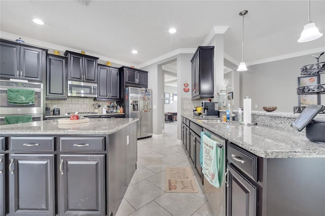 kitchen with ornamental molding, pendant lighting, tasteful backsplash, and stainless steel appliances