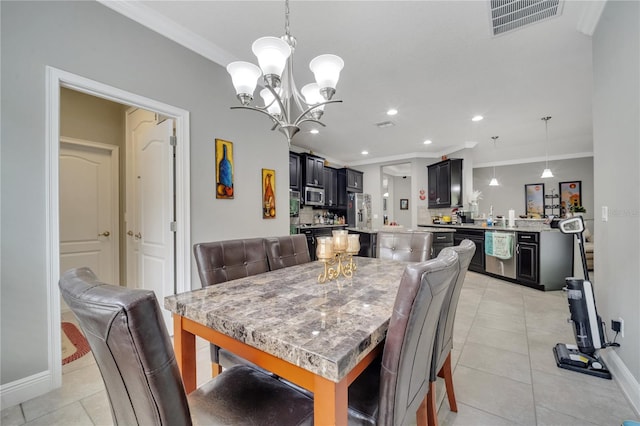 dining area featuring an inviting chandelier, light tile patterned floors, and ornamental molding