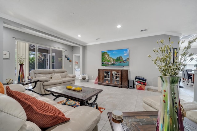 living room featuring tile patterned floors and ornamental molding