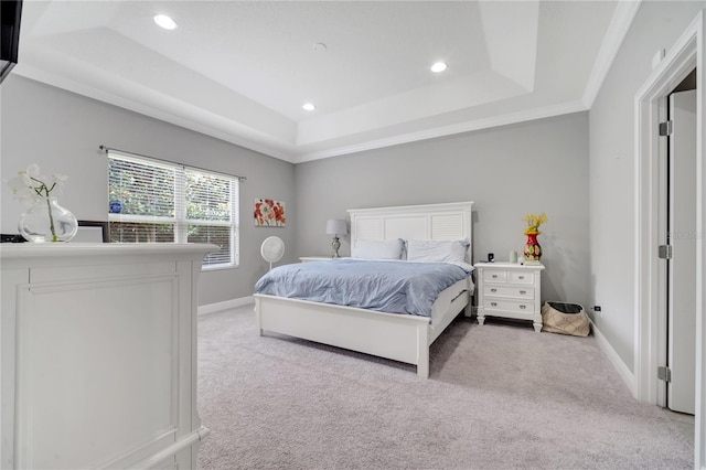 bedroom featuring a tray ceiling, ornamental molding, and light colored carpet