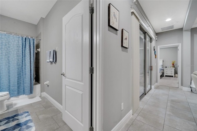 12151 Alder Branch Loop, Orlando, FL 32824 - corridor featuring light tile patterned flooring and baseboards
