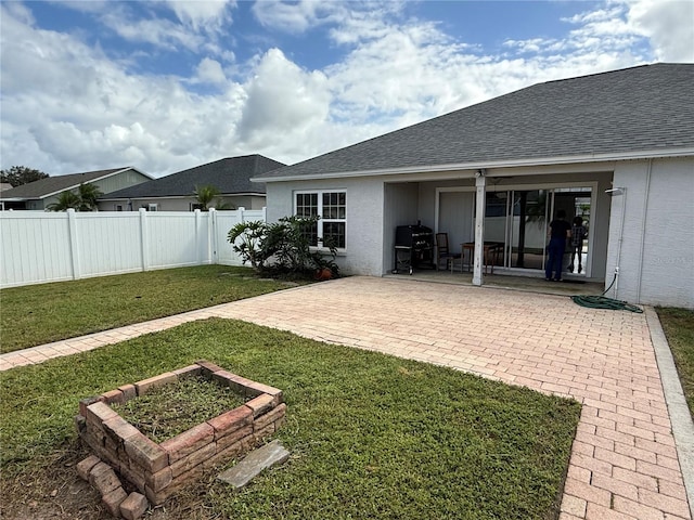 back of house featuring a patio area and a yard