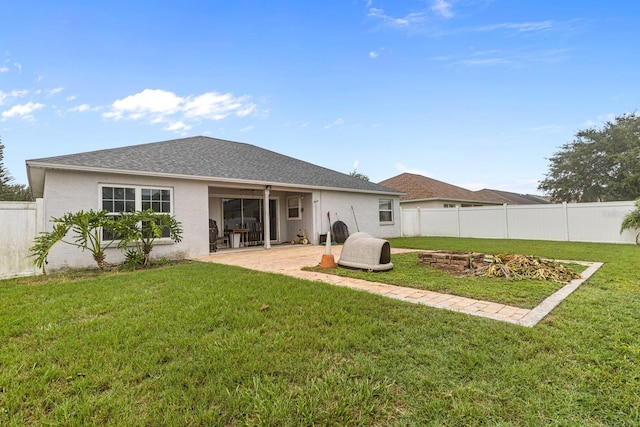 rear view of house featuring a patio area and a lawn