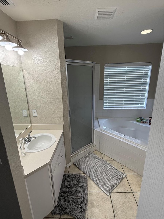 bathroom featuring vanity, tile patterned floors, and plus walk in shower