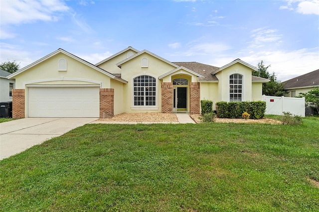 ranch-style home featuring a garage and a front lawn