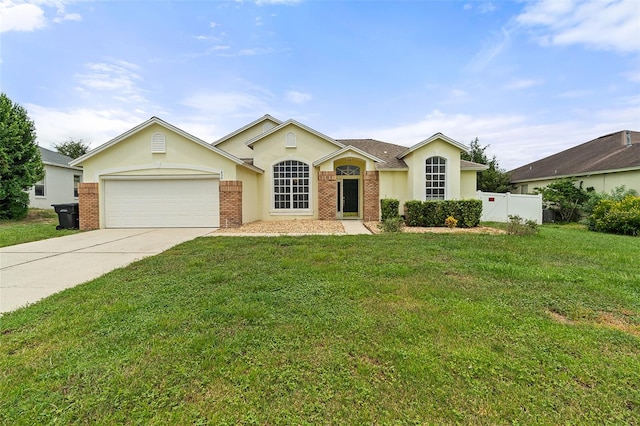 ranch-style home featuring a garage and a front lawn