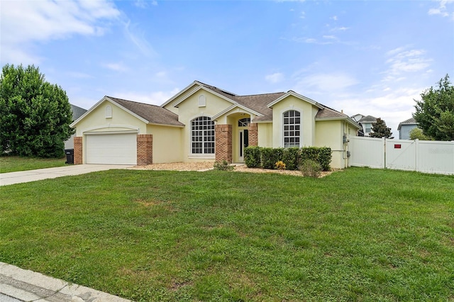 ranch-style home with a garage and a front lawn