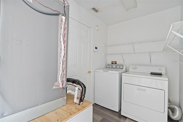 laundry room featuring independent washer and dryer and dark hardwood / wood-style floors