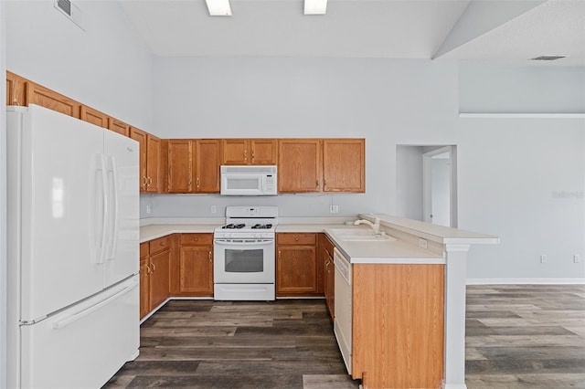 kitchen with dark hardwood / wood-style flooring, white appliances, high vaulted ceiling, and sink