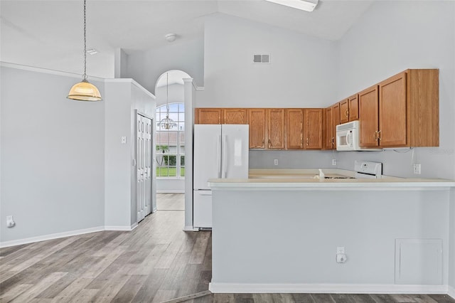 kitchen featuring white appliances, pendant lighting, kitchen peninsula, high vaulted ceiling, and light wood-type flooring