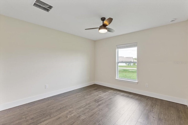 spare room featuring hardwood / wood-style floors and ceiling fan