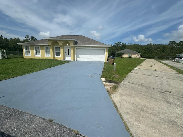 view of front of property with a garage and a front yard