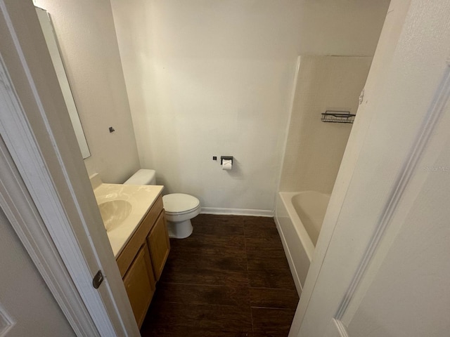 full bathroom with vanity, wood-type flooring, toilet, and  shower combination