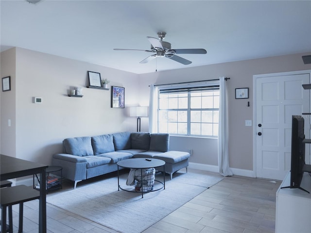 living room with ceiling fan and light wood-type flooring