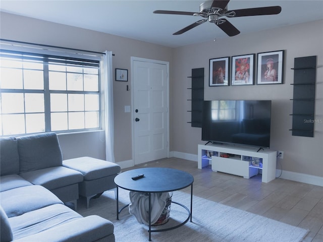 living room featuring hardwood / wood-style flooring and ceiling fan