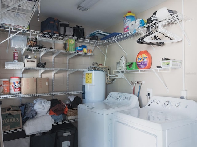 clothes washing area with water heater and independent washer and dryer