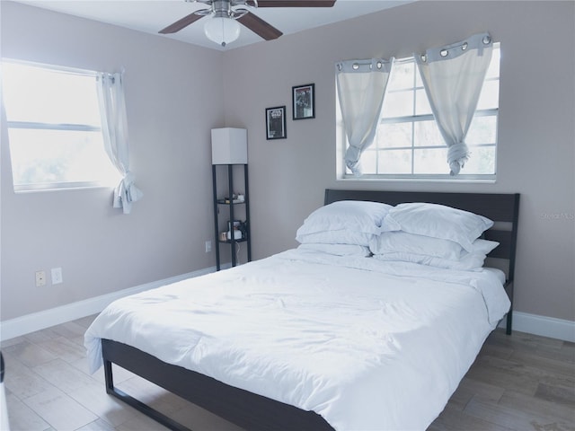 bedroom with hardwood / wood-style floors and ceiling fan