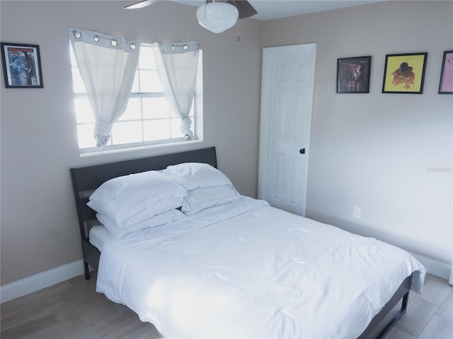 bedroom featuring wood-type flooring and ceiling fan