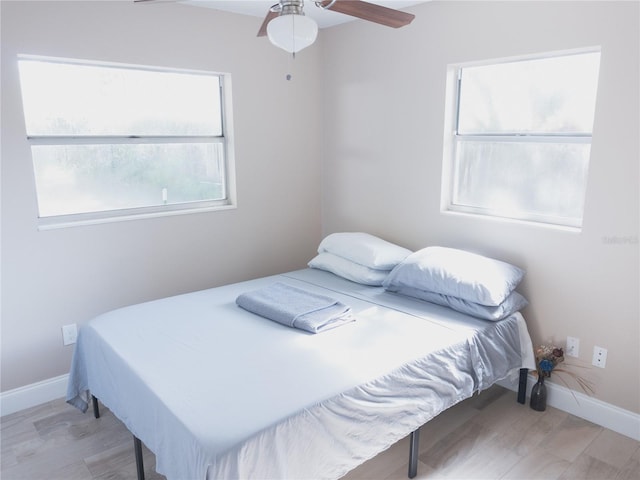 bedroom featuring ceiling fan and light hardwood / wood-style flooring