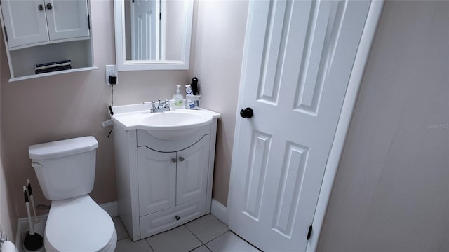 bathroom with vanity, toilet, and tile patterned flooring