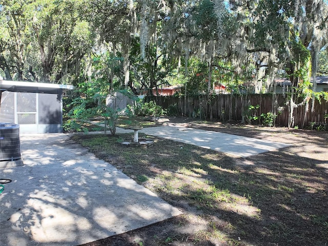 view of yard with a storage unit and central AC unit