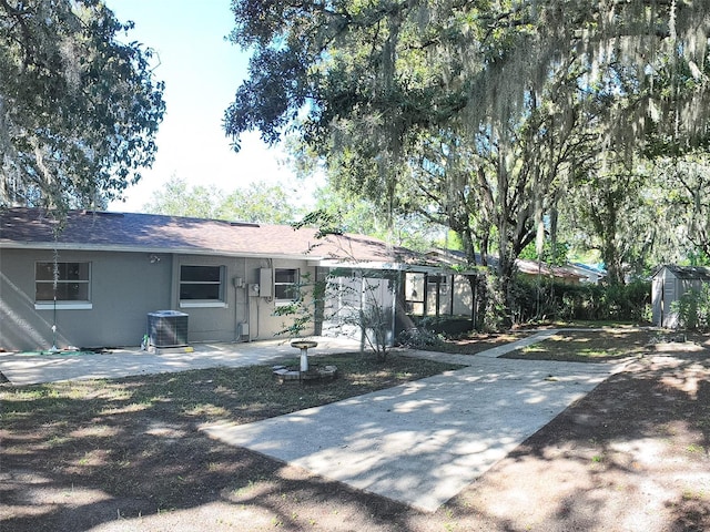 ranch-style house featuring a patio and central air condition unit