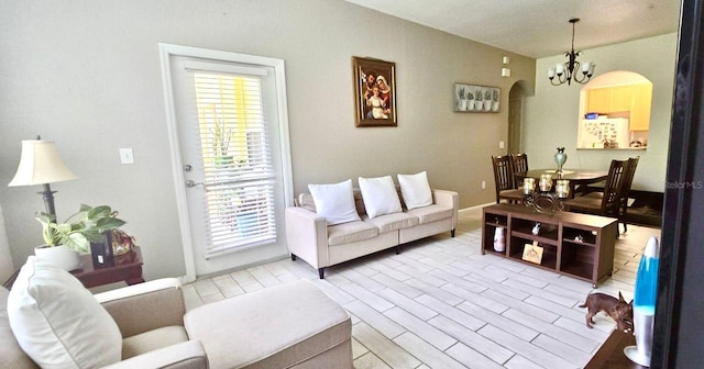 living room featuring a chandelier and light hardwood / wood-style flooring