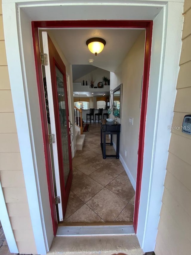 corridor featuring lofted ceiling