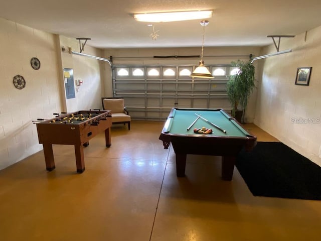 recreation room with pool table, concrete flooring, and electric panel