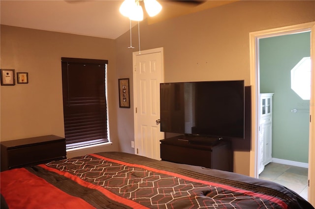 bedroom with ceiling fan and light tile patterned floors