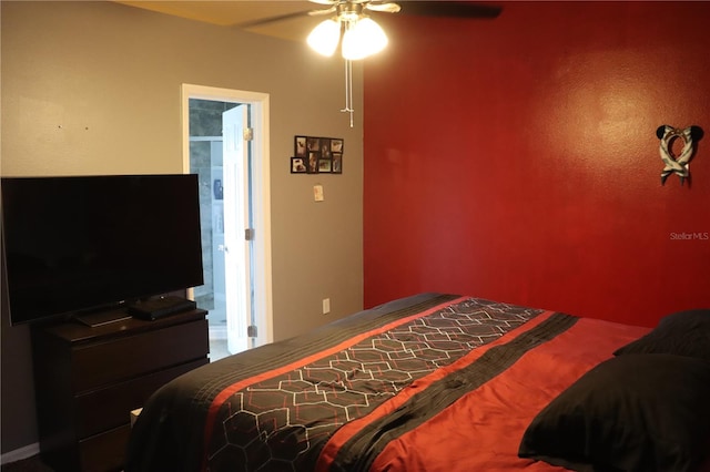 carpeted bedroom featuring ensuite bathroom and ceiling fan