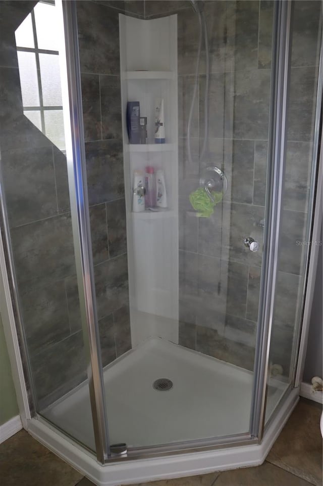 bathroom featuring walk in shower and tile patterned floors