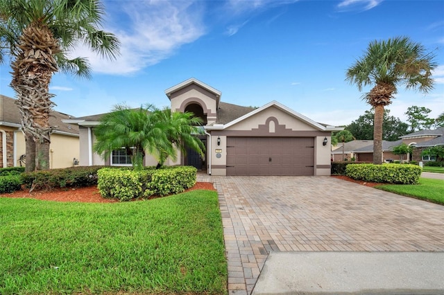 ranch-style home with a garage and a front yard