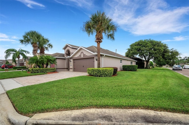 single story home featuring a garage and a front lawn