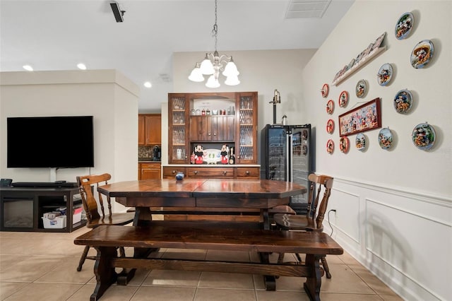 dining space featuring light tile patterned floors and a chandelier