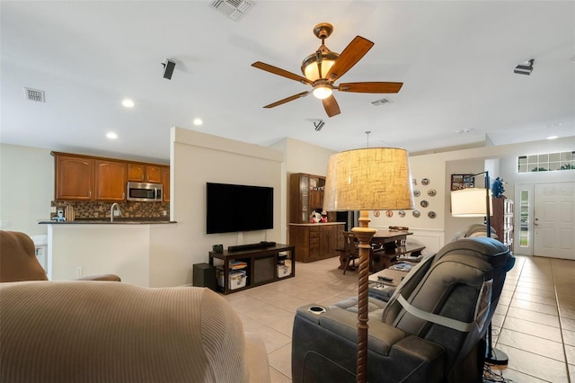 living room with light tile patterned floors and ceiling fan