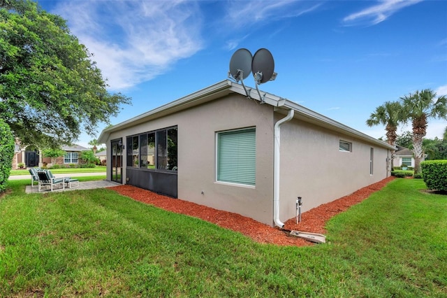 view of side of property with a lawn