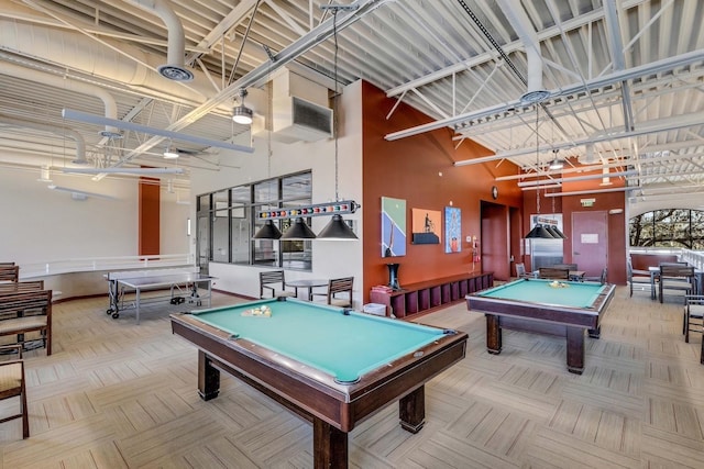 playroom with a towering ceiling, parquet floors, and billiards