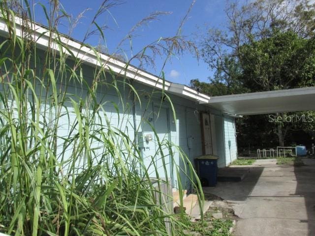 view of side of property featuring a carport