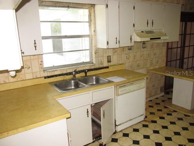 kitchen with white cabinetry, dishwasher, sink, and backsplash