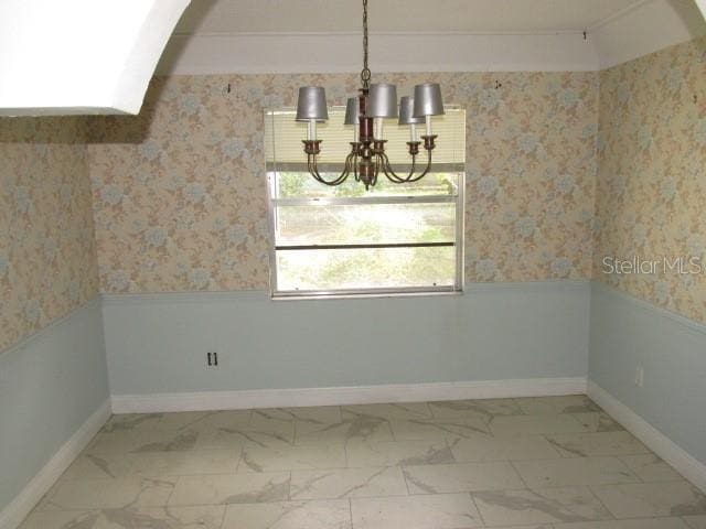 unfurnished dining area with a notable chandelier