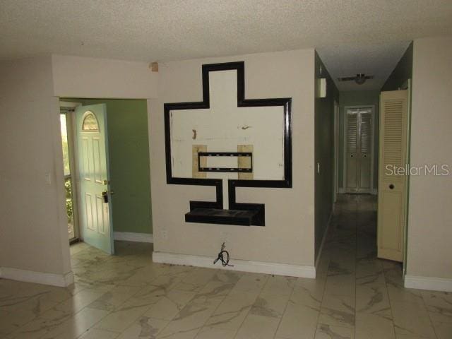 hallway with a textured ceiling