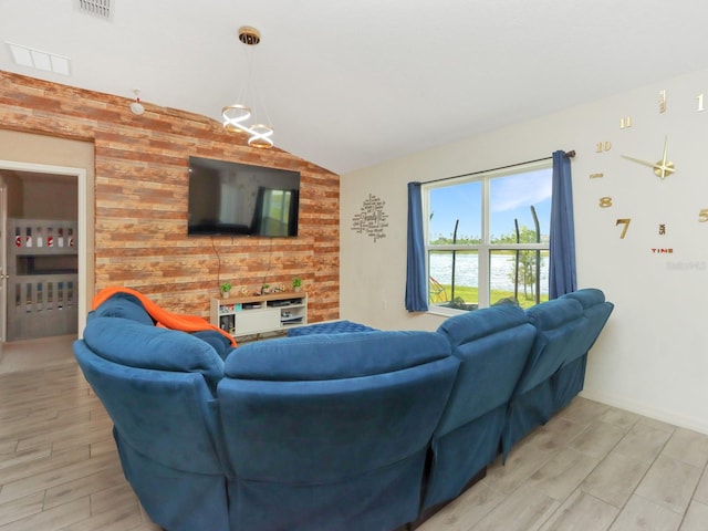 living room with wood-type flooring, wood walls, and vaulted ceiling