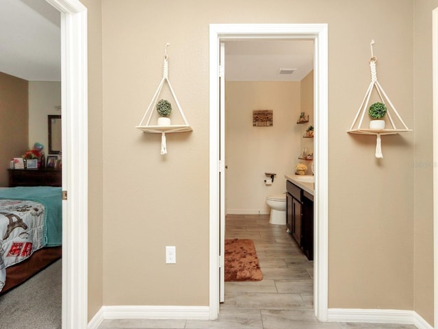 bathroom featuring wood-type flooring, vanity, and toilet