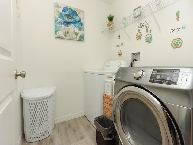 laundry area featuring light hardwood / wood-style floors and independent washer and dryer