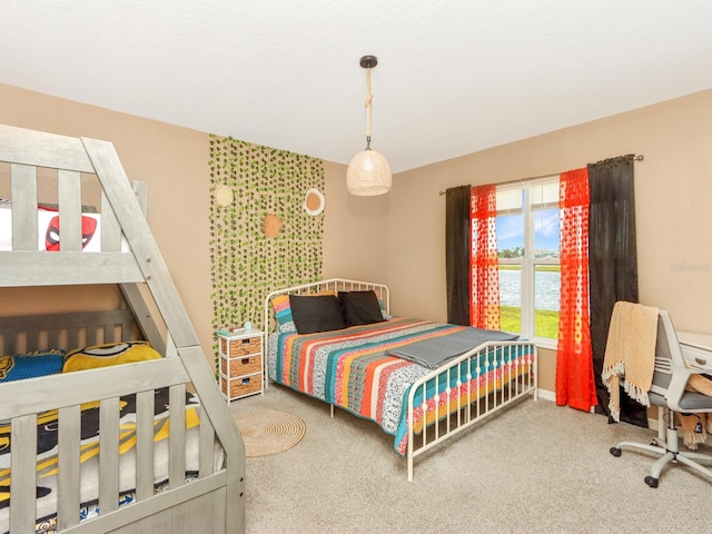 carpeted bedroom with a water view